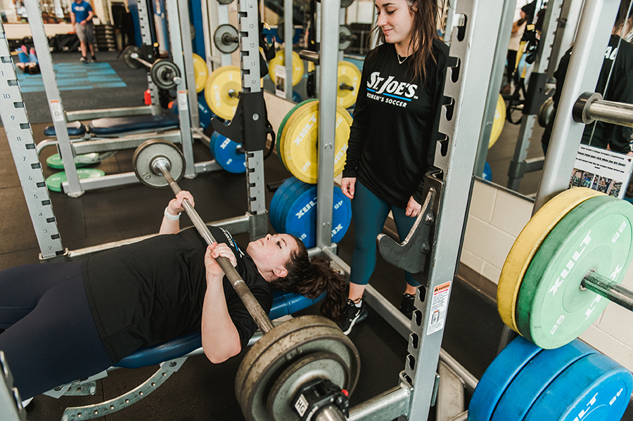 Students working out in the Alfond Center weight room