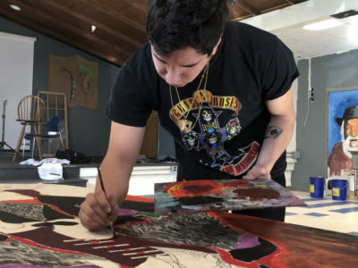Caleb Levine works on a large-format