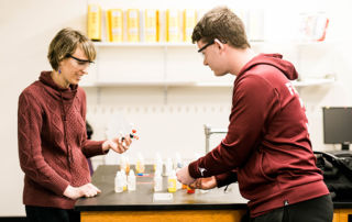 Dr Emily Lesher works with a science student in the chemistry lab at Saint Joseph's College in Standish, Maine