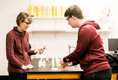 Dr Emily Lesher works with a science student in the chemistry lab at Saint Joseph's College in Standish, Maine