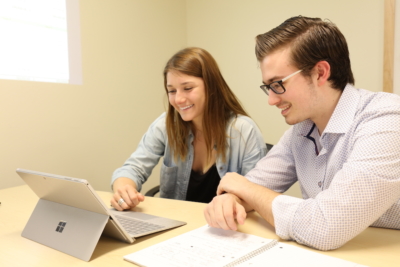 Hayley Winslow and Nick Guidi discuss business plans, using an iPad and spreadsheets