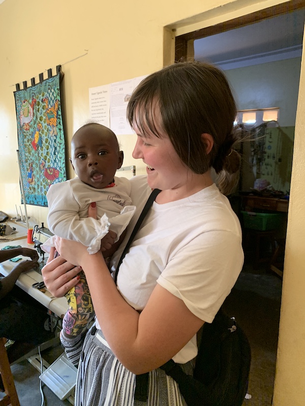 April Benak working with a baby in Uganda