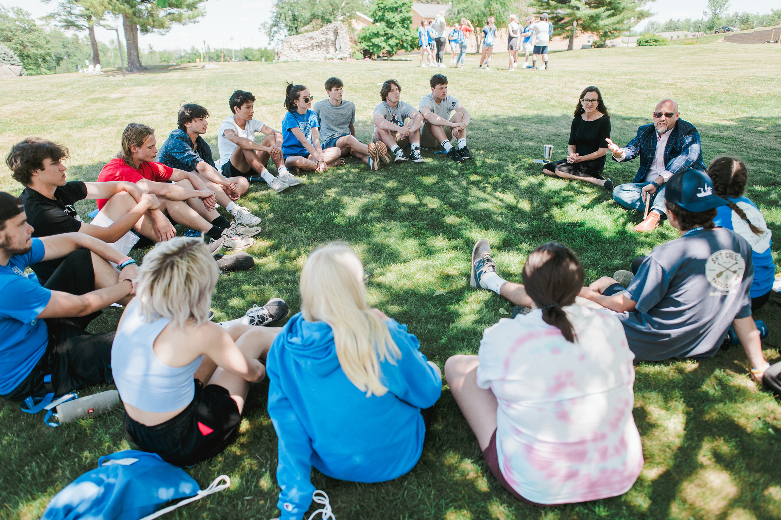 Students in an outdoor class speak with Leadership for Sustainable Communities professors