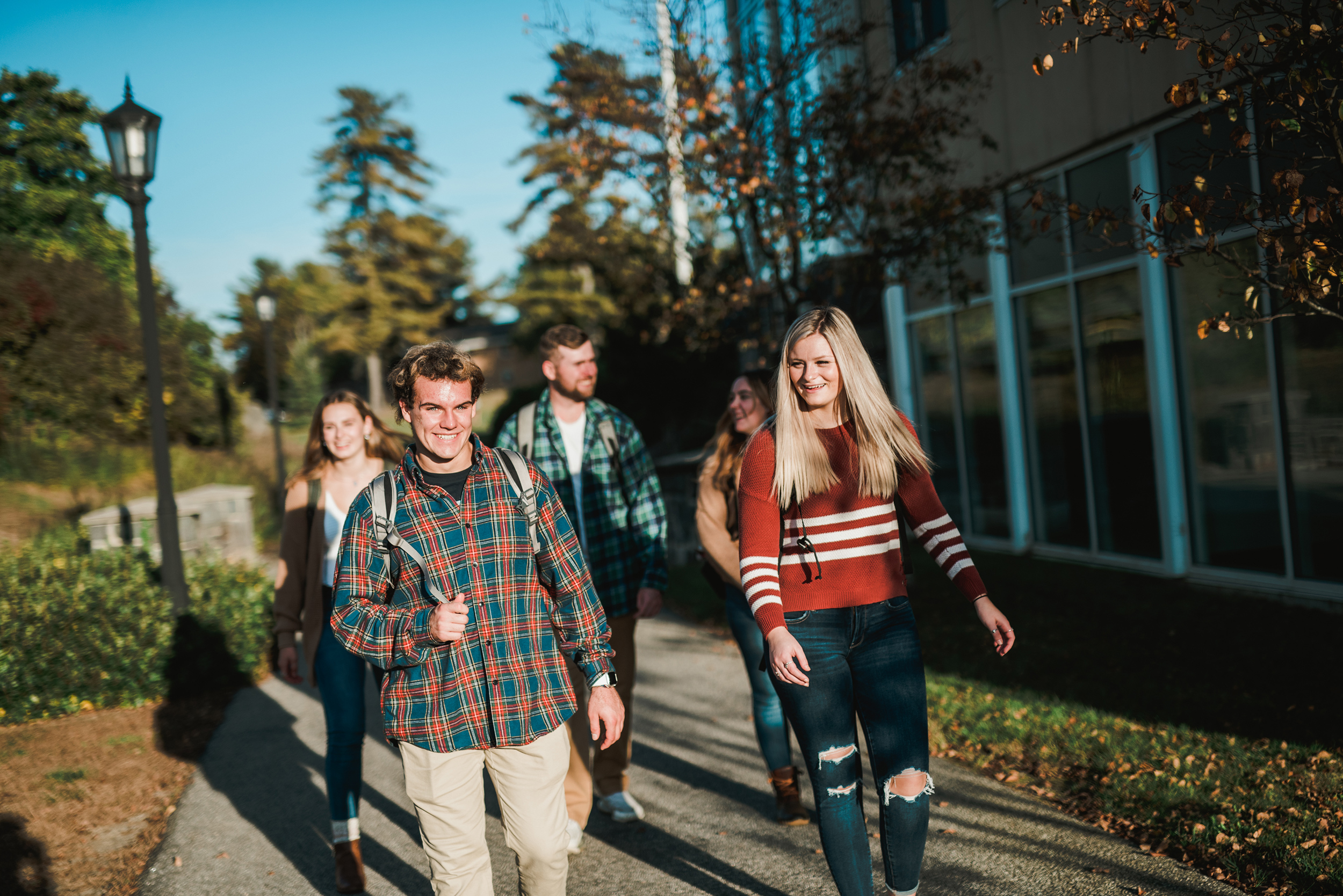 students walk across campus in the fall