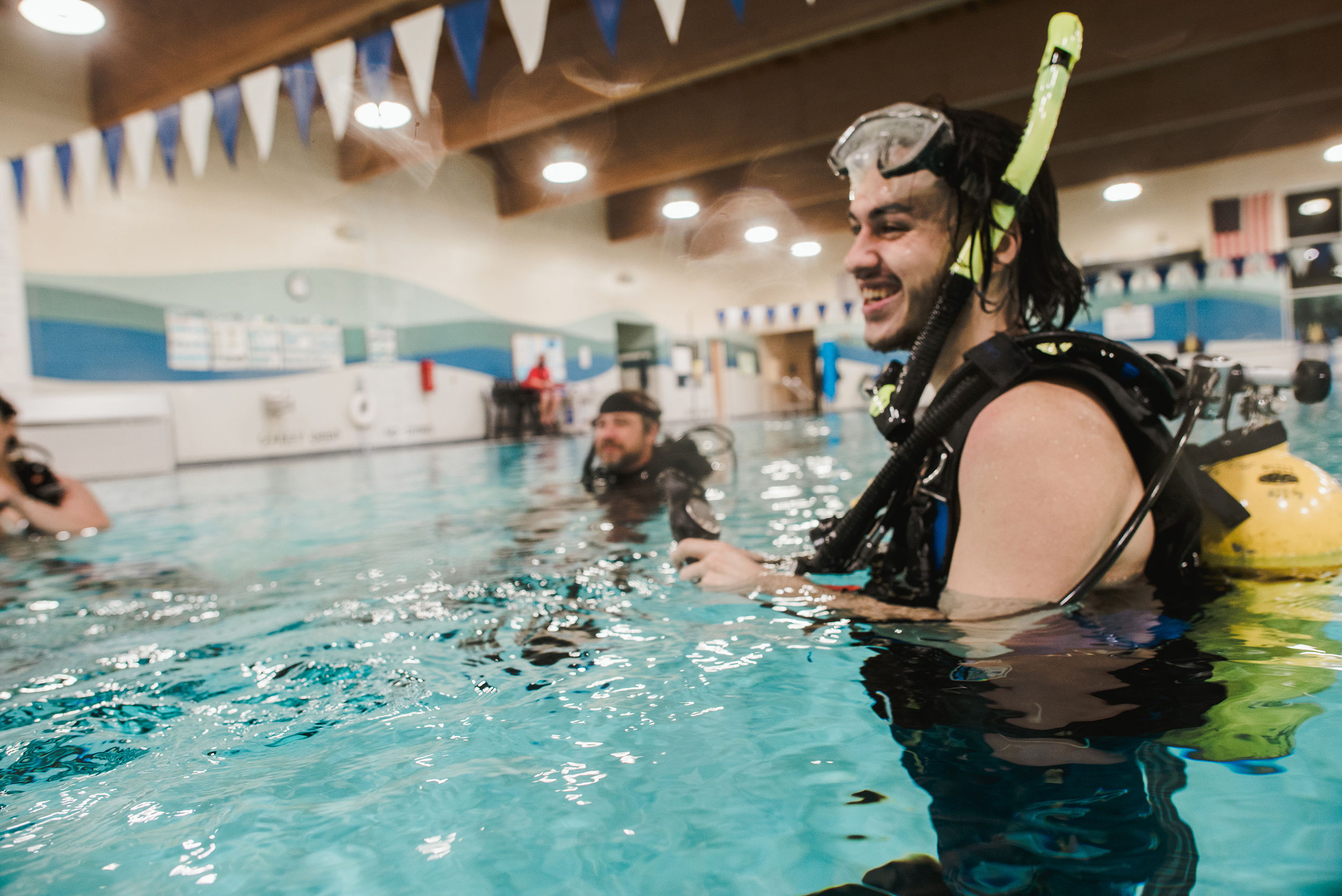 Science students practice scuba diving in the pool