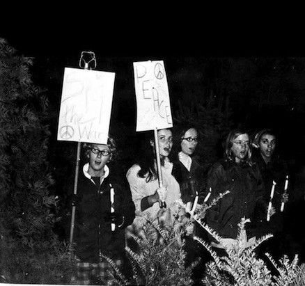 Students in 1969-70 hold signs that say “Stop the War” and “Peace.” 
