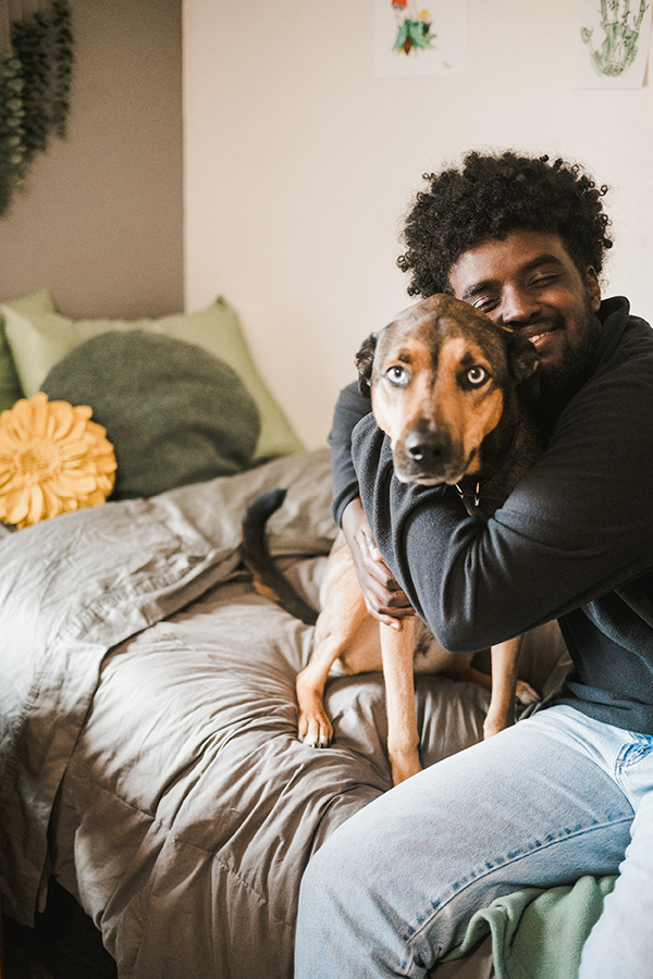 Male student and his dog live in pet friendly housing.