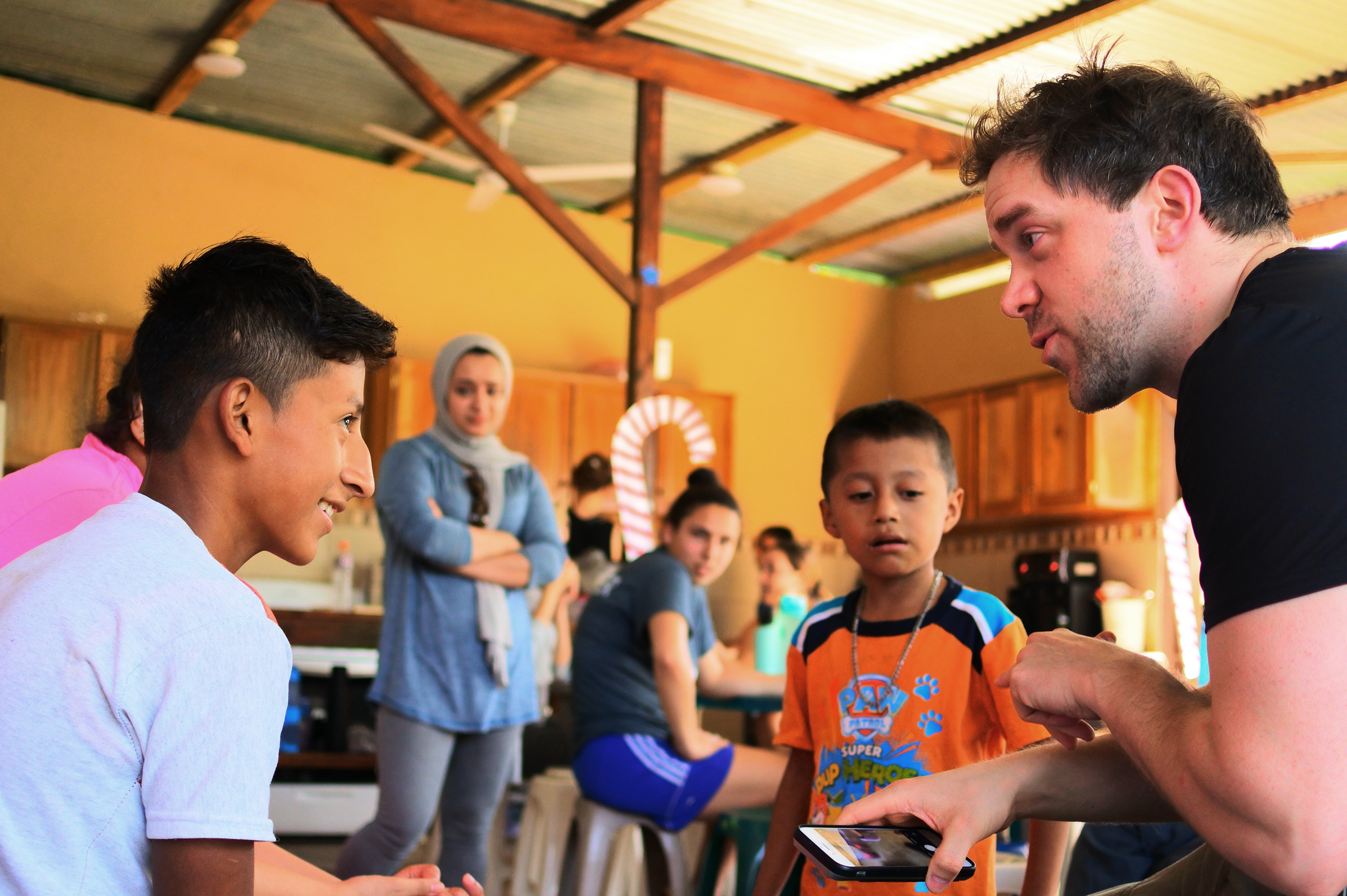 Student talks with area children during international service trip to Guatemala.