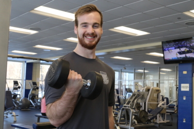 Tommy lifts weights in the Alfond Center