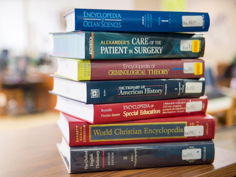 Stack of books from the Wellehan Library at Saint Joseph's College of Maine
