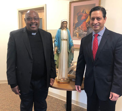 Fr Gabriel and Vincent Palange II stand beside the donated Blessed Mother statue