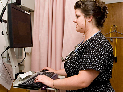 health care professional at a computer station