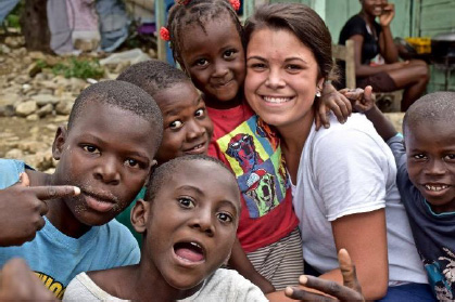 SJC student with Haitian children