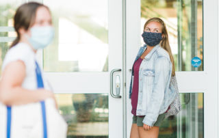 female students wearing masks outside