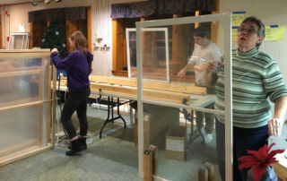 students work on window weatherization project